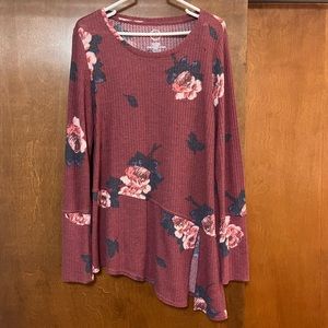 Mauve and floral long sleeve blouse with asymmetrical hem and slit detail.